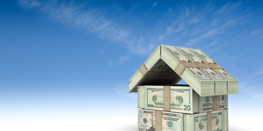 House made of dollar bill stacks against a sky blue background.